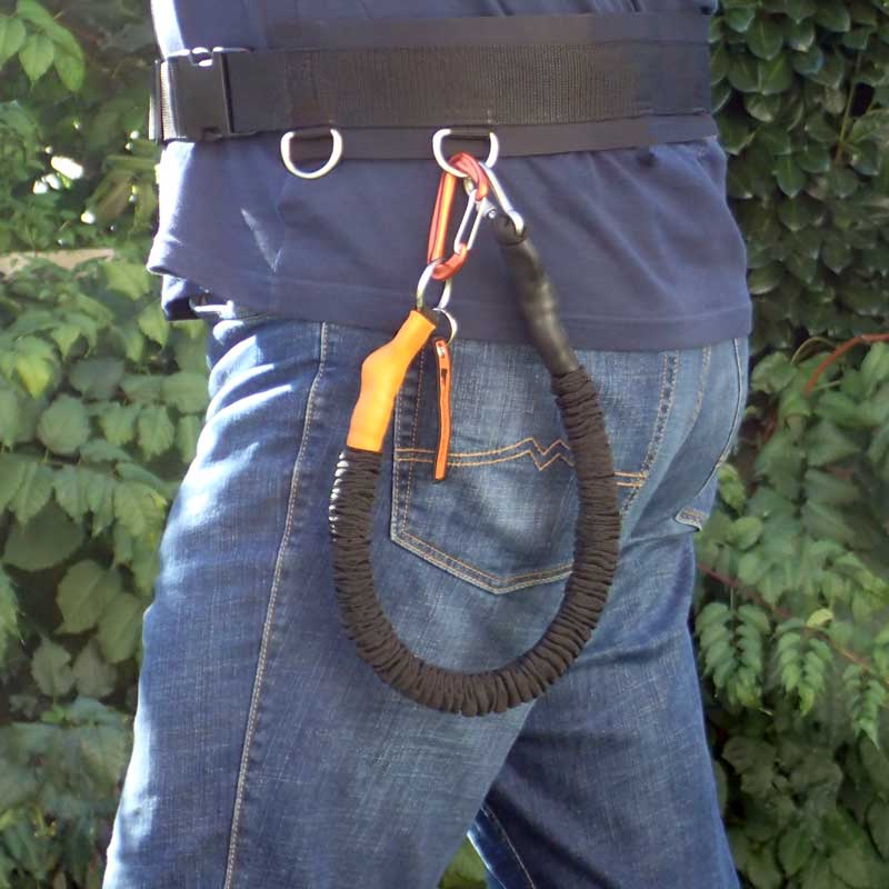 The ultra leightweight hip belt for hands free hiking with dogs on leash outdoors. Product picture shows person in nature wearing waist belt with leash expander.